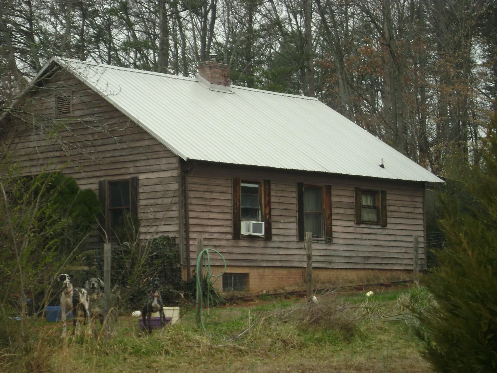 White metal roof on an old wood sided farmhouse, from a Metal Roof Installation job in Windsor